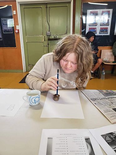 Giving a clay bear, she made at our Art KIT Day in Palmerston North, some legs and arms and ears.