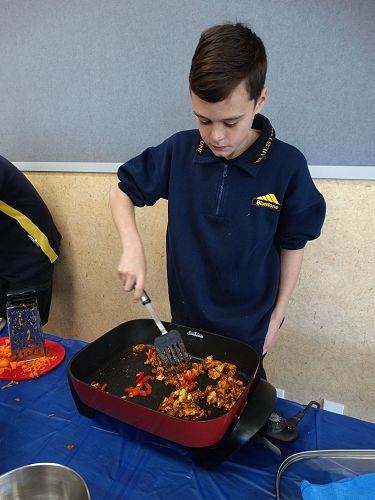 Zac turning the meat to make sure it is properly cooked