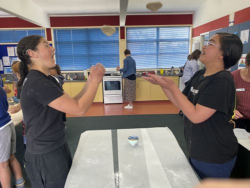 Te Maire and Rhythm spining their pizza dough