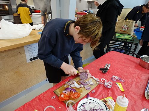 Riley chopping the onions. A few tears were shed!