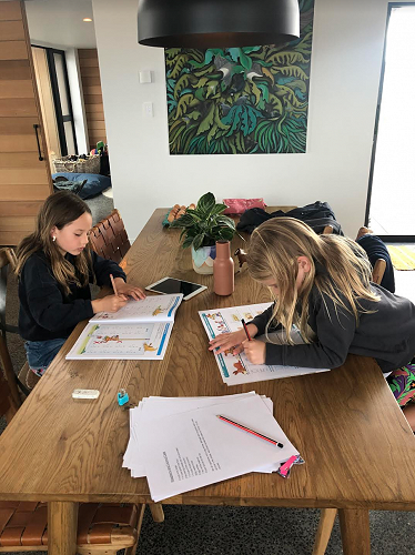 Poppy (Year 4) and Charlotte (Year 2) Hussey are busy as bees working from home.