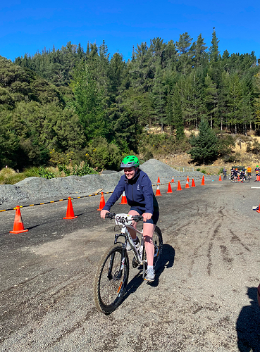 Tylah James finishing a lap of the mountain biking course for her all girls team