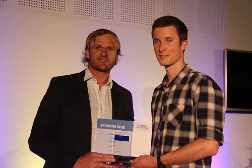 Scott Robertson presenting Joseph Williams with his Lincoln University Blue for Squash