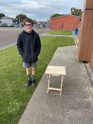 Max with his table he made for woodwork
