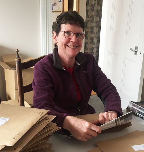 Volunteer Kathleen Currie packing June 2022 magazines for the international mail (27 May 2022)