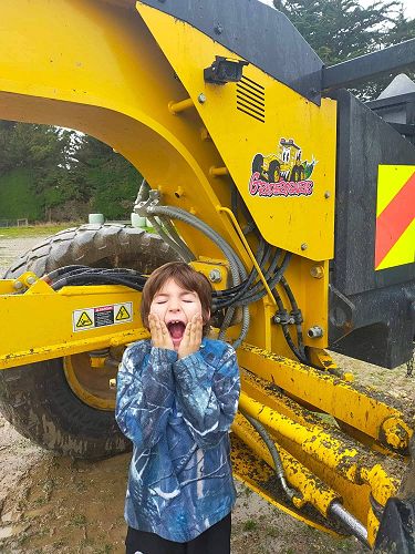 Travis Steel from Heriot School won a competition to name a new grader. He was super excited to see Graderosaurus hard at work 