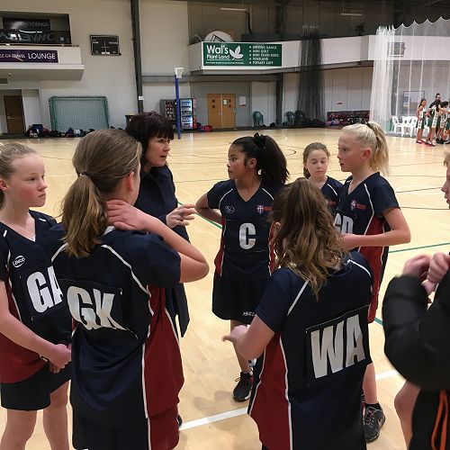 Coach Rachel Mortimer gives some sound advice during halftime in the year 7 Gold netball game at the junior catholic schools tournament.