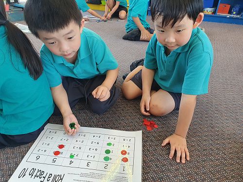 WinLong and Alan playing 'Roll a Fact to 10'