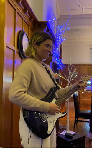 Sienna Harper playing guitar