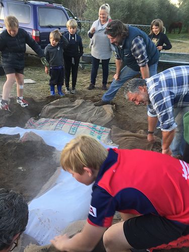 We had to be careful as we rolled the sacks off the hangi pit so that as little soil as possible landed on the parcels.