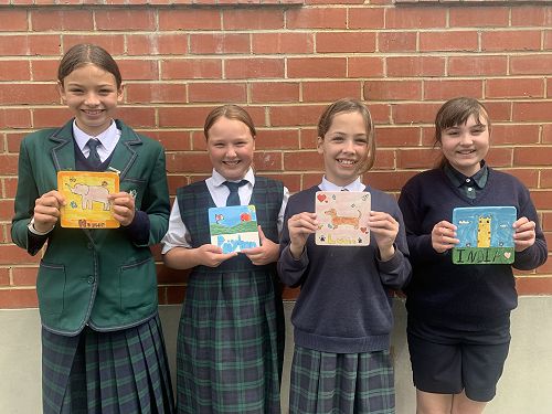 Honor Blaikie, Paiyton Dixon, Lucia Garcia-Quiroga and India Allison with their finished tiles.