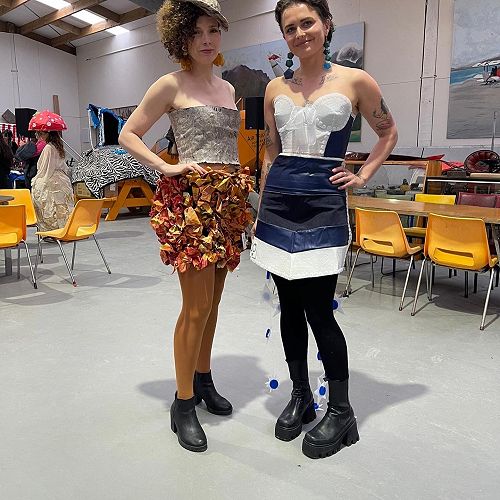 "Autumn Paper" by Meka White, Tahlia Williams-Green, and Mylee Gibson worn by model Pauline (Left) and Mrs. Peneamne wearing her entry, "Sweet Dreams Baby" (Right), at the Junk2Funk exhibition in Hokitika