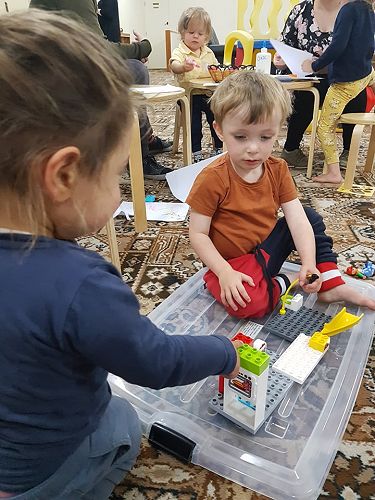 Sadie Houston and Edison Moore playing with the duplo together
