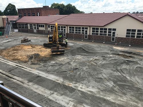The now empty site where the old assembly hall once stood has been paved over.