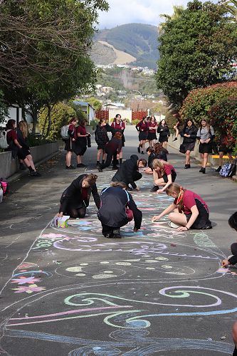 Colouring in the Kowhaiwhai on the central driveway as part of cultural diversity week.