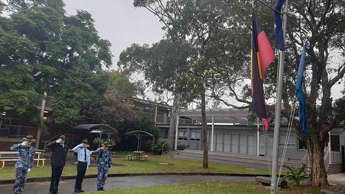 Flag bearers raising our flags following the ceremony