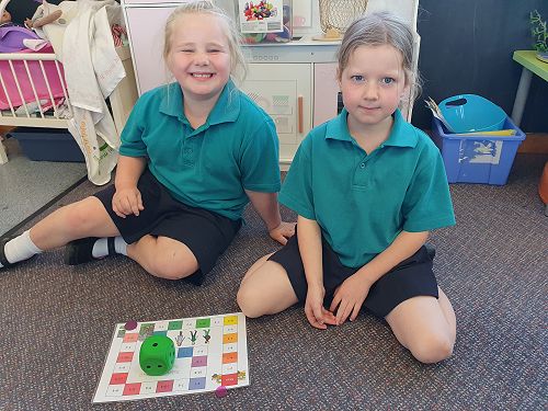 Isla and Louisa playing an addition boardgame