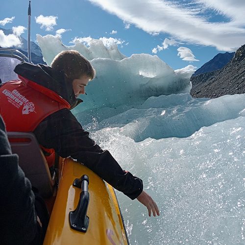 Archie touching a piece of glacial carving from the Tasman Glacier