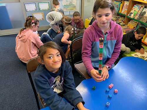 Faith and Sophie creating patterns in Maths