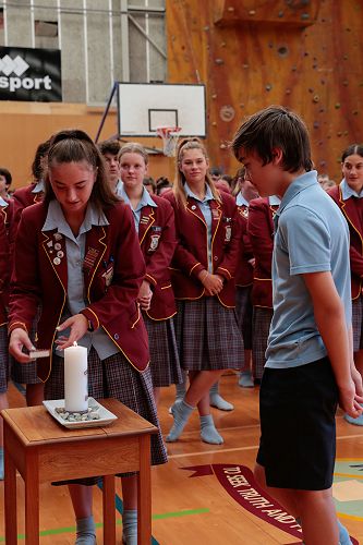 Year 13 student, Eve Benson and her younger brother, Lucas lit a candle to show our coming together as one community.