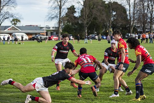 Tackle: Alex Schupbach slows down the St Thomas's attack.