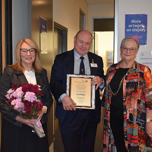 Margaret Beare, Art Show convener, presenting 40 year appreciation award to Jeff and Jenny Neale, Paradise Mazda