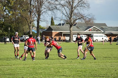 Battle: Junior Harris carries strongly against a physical defence.