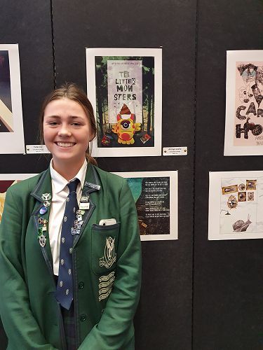 Amaya Leslie next to her winning Designs. Book cover for "The Litter Monsters" and her double page spread.