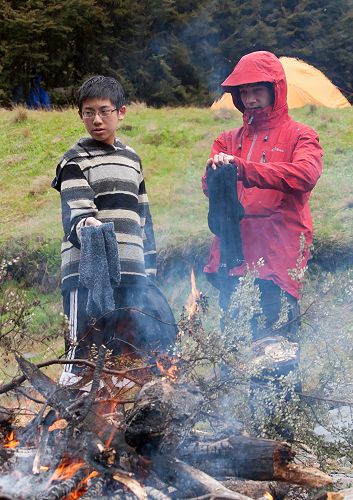 Boen Deng and Ben Wishart dry their socks after a snowy days walk.