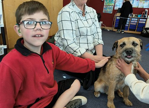 John is learning how to safely interact with a dog.