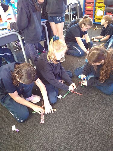 Gracie Fisher, Charlotte Bloxham, Emily McElhone and Mia North cutting and weaving their stars