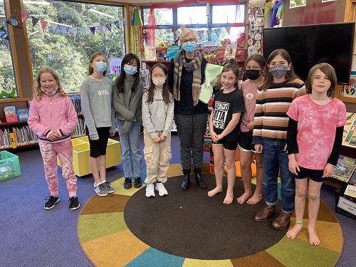 Laura is presented with flowers from the Book Battle Team