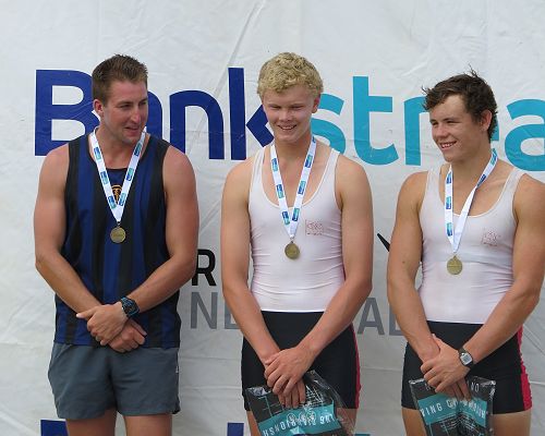 Logan Keys, rowing coach on the podium with Angus Foster and Jack Lopas at the National Rowing Club Championships