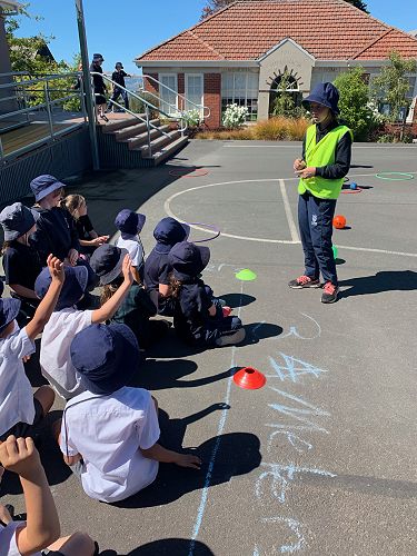 Isabella van Aart teaches younger children a new game.