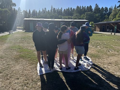 This team were quickly successful at flipping over the sheet while all standing on it