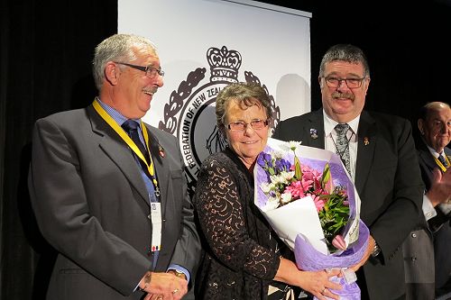 Convenor Ian and wife Liz receiving flowers from CJPA President BJ Clark