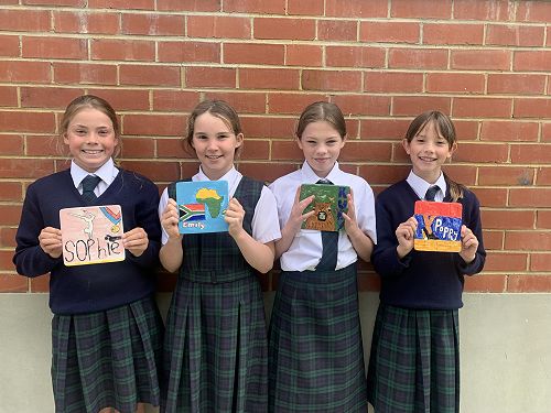 Sophie Wellington, Emily North, Ruby Tilyard and Poppy Hussey with their finished tiles.