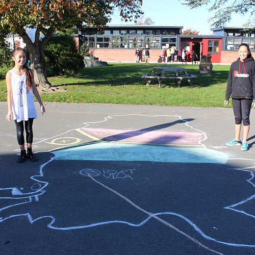 Anika and Amy-Lee with their chalk drawn Vanuatu.