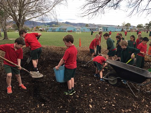Working together to fill the buckets and wheelbarrows