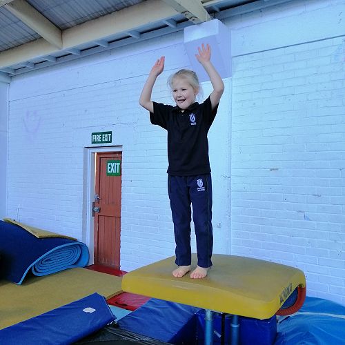 Michaela jumping onto the big trampoline.