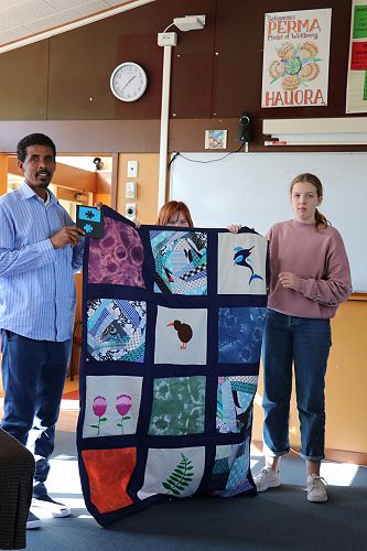 Fishale Weldesilase presented the quilt by Shakia & Grace