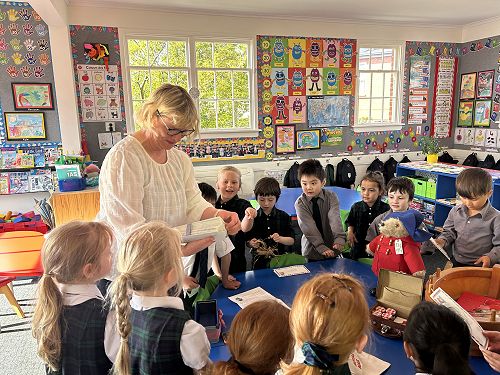 Miss Eason handing out personalised invitations