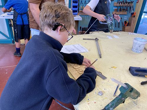 Jordan designing his name board at Hard Tech