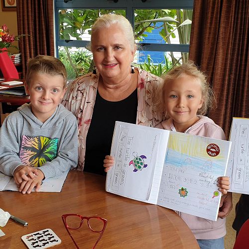 Luca, Kobi, Harper & Xavier showing Mrs Augustine their fabulous writing!