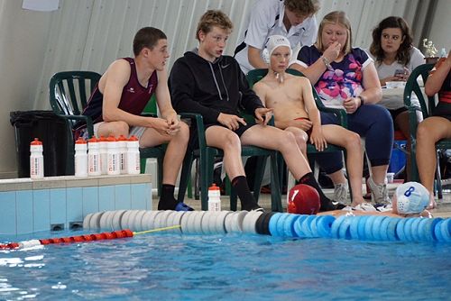 The coaches talking to the team.