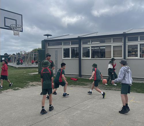 Jacky is playing basketball with his new friends at Tech.