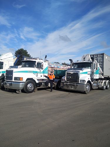 Kadin with the company trucks that he cleans and maintains in between crane jobs