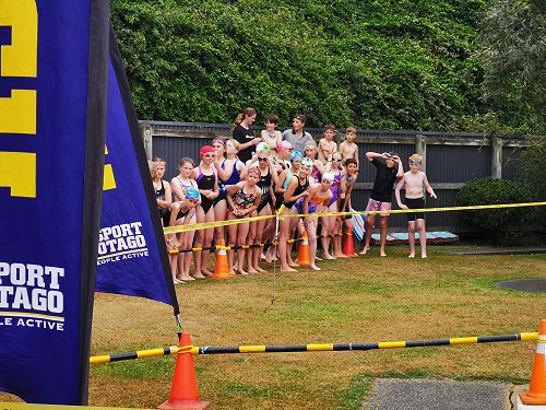 Swimmers eagerly await the arrival of their teammates