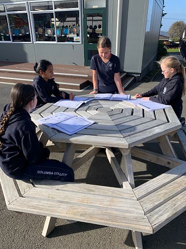 Sophie Butson leads Ruby Acklin, Srishti Singh and Elodie Brown in a group discussion on the chapters they have focused on
