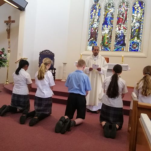 Fr Mat commissioning students as Eucharistic ministers at the Feast day Mass for St John Paul II. 